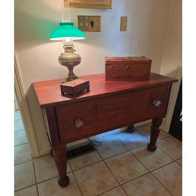 An exceptional piece of early American utilitarian craftsmanship, this massive solid cherry work table dates to circa...