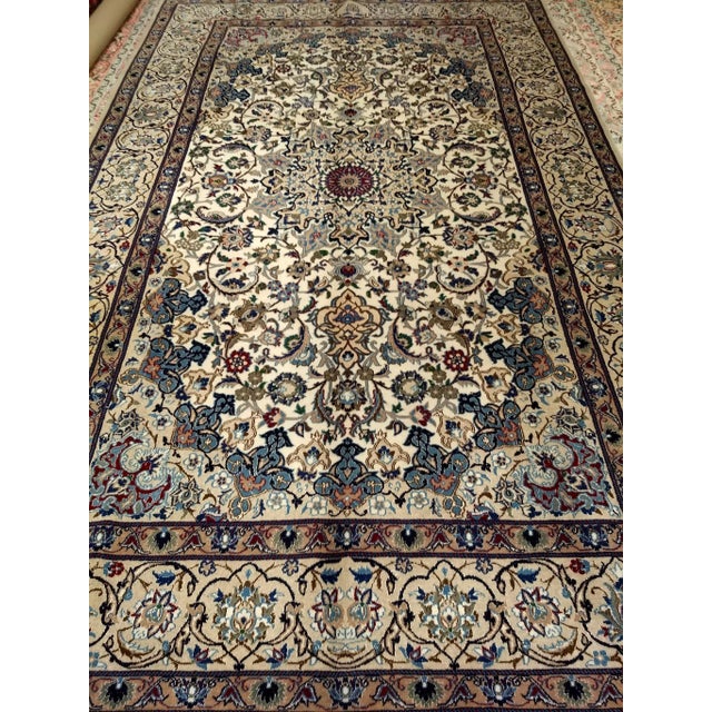 This vintage Persian Nain rug offers a rare and unusually warm interpretation of the classic Nain design vocabulary —...