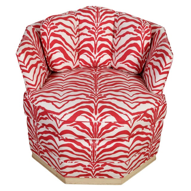 A pair of vintage swivel barrel chairs, newly upholstered in red Sister Parish animal print. A comfortable, octagonal...