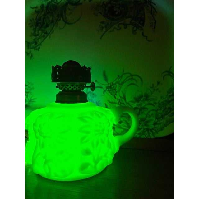 Antique Edwardian miniature finger lamp (circa 1890–1910). Crafted from uranium (vaseline) glass with high-relief floral...