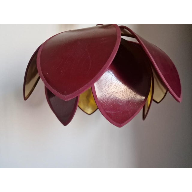 Lotus flower pendant light by Robert de Schuytener from the 1980s. It features 12 burgundy lacquered petals and a gold...