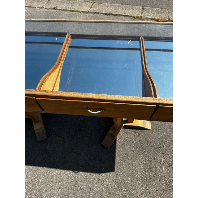 Oak cabinet. Four drawers with handles, glass display cases, removable mirrored interiors. Legs adorned with brass plates....