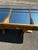 Oak cabinet. Four drawers with handles, glass display cases, removable mirrored interiors. Legs adorned with brass plates....