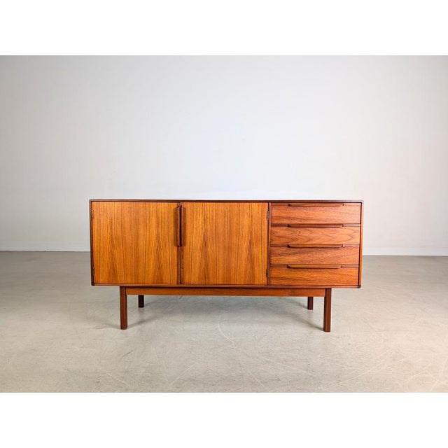 Beautiful vintage sideboard by Asko Finland from the 1960s. The piece offers generous storage space behind two large doors...