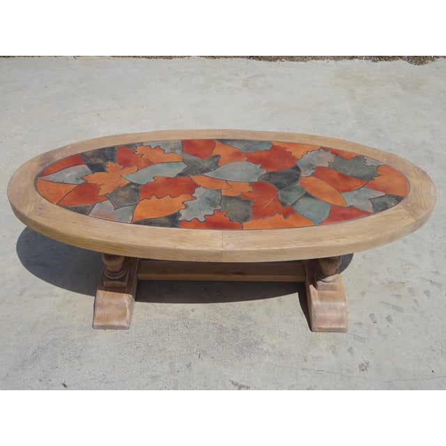 Oval tabletop, Vallauris ceramic in a colorful leaf pattern, lovely pastel shades. Solid oak frame, monastery-style base,...