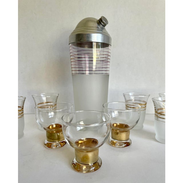 Here is an amazing, Art Deco set of 10 total pieces to amp up your bar game! There is a large mixer with silver aluminum...