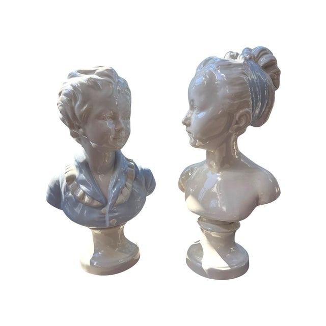Charming pair of vintage Italian white ceramic figural busts depicting a young boy and girl, designed as a coordinated...