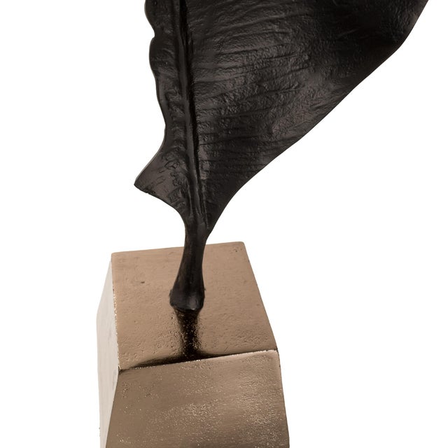 Crafted from aluminum, each piece showcases a unique abstract leaf form in contrasting black and bronze finishes. Elevated...