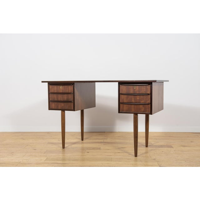 This freestanding desk was produced in Denmark in the 1960s and is an excellent example of Scandinavian Mid-Century Modern...