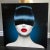 A stunning large format photography mounted on acrylic featuring a woman with jet back hair and porcelain skin-- very...