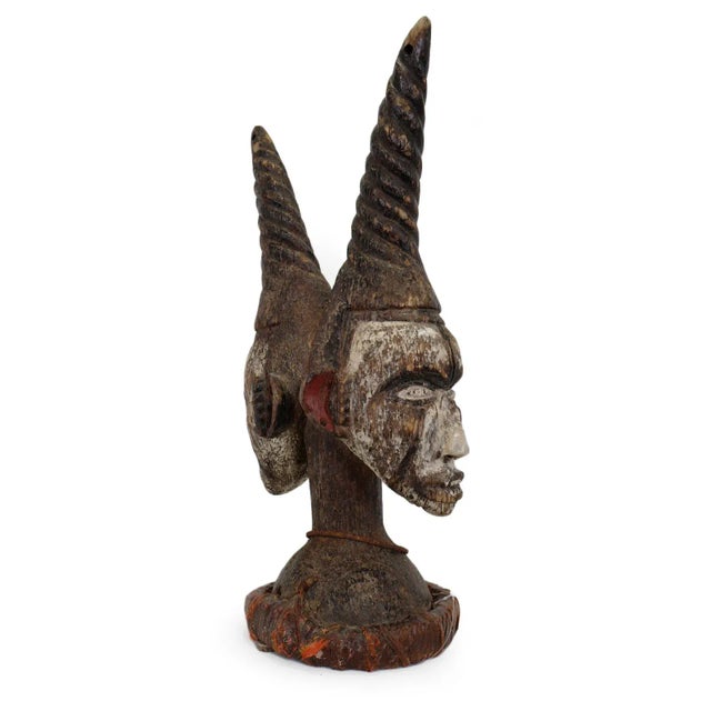 Striking antique Igbo double-faced ceremonial headdress from southeastern Nigeria. Hand-carved in wood with beautifully...