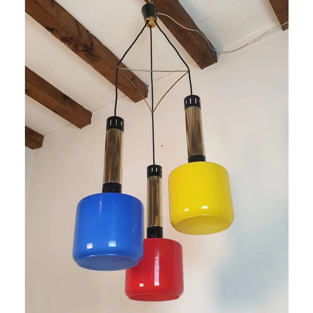 Glass and brass pendant chandelier, by Stilnovo, Italy 1960s. Three primary colors glass shades for this original Italian...