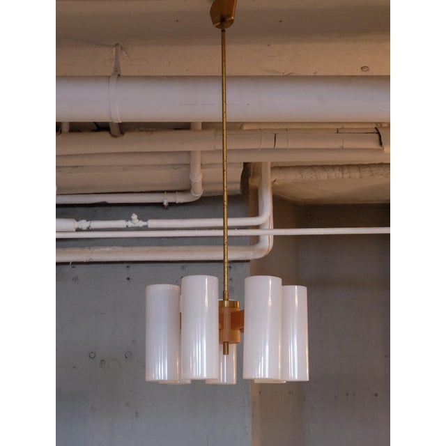 This pendant was designed by Uno & Östen Kristiansson for Luxus. It features solid pine, polished brass, and large acrylic...