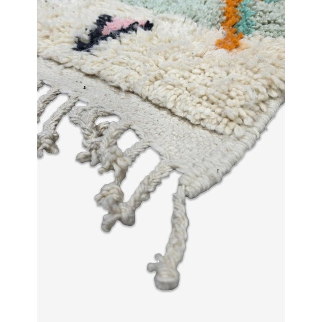 Boho Moroccan Rug – Handmade Tribal Berber Wool Rug This vibrant handmade Moroccan rug features a fresh teal wool field...
