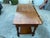 This antique Arts and Crafts oak library desk writing table with a shelf in a mission style is a vintage console table...