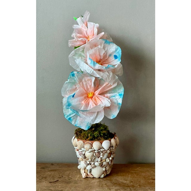 Contemporary hand-rolled paper flowers are a modern, artistic take on traditional floral arrangements. These flowers are...