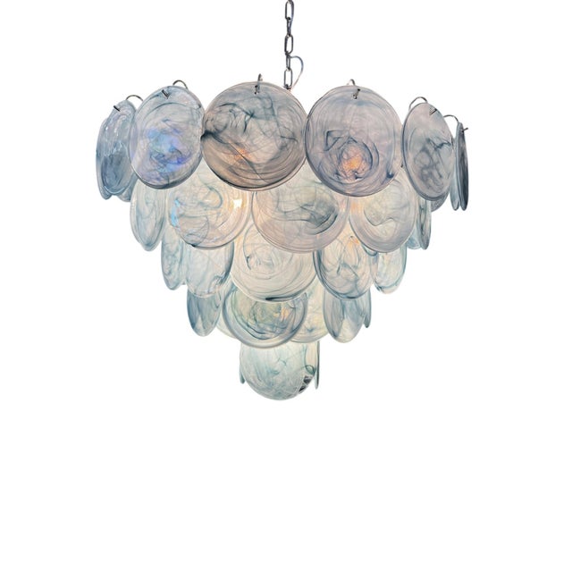This striking chandelier is crafted in authentic Murano glass, showcasing the excellence of traditional Venetian...