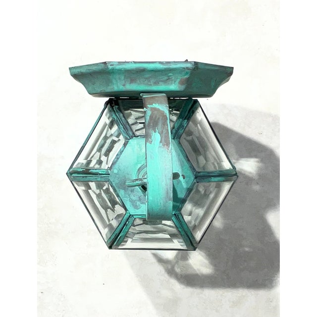 vintage-inspired petite wall lantern. Crafted from solid brass, this pocket-sized sconce boasts a remarkable, verdigris...