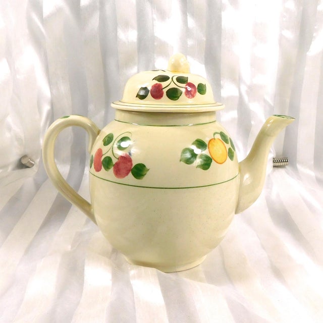 This is a Royal Adams Titan Ware teapot in an unknown pattern.The teapot is off white with a pattern of lemonds, apples or...