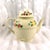 This is a Royal Adams Titan Ware teapot in an unknown pattern.The teapot is off white with a pattern of lemonds, apples or...