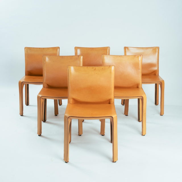 Set of 6 Model 412 "Cab" Dining Chairs in Cognac Saddle Leather by Mario Bellini An extraordinary and highly sought-after...
