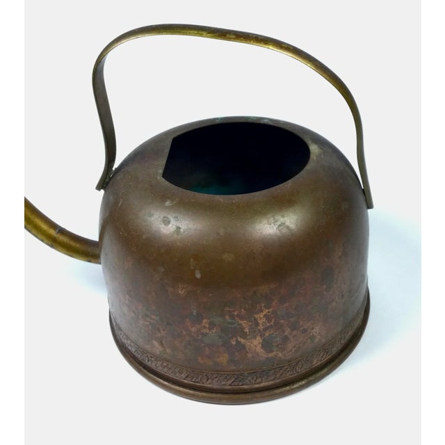 Absolutely beautiful piece of art and history. This little antique water can is made with copper and brass. The main body...