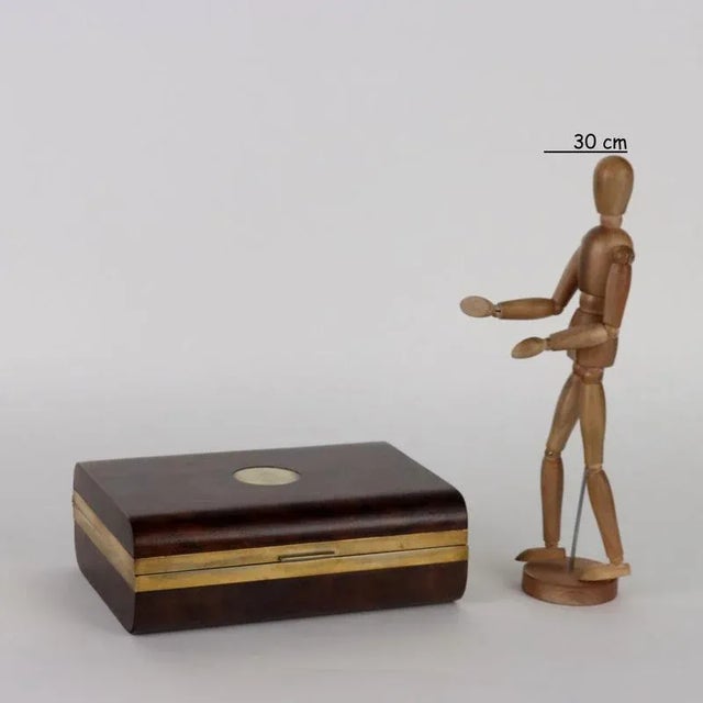 Casket in maple wood and walnut root with rounded corners, edges and decoration on the brass lid. Dealer label under the...