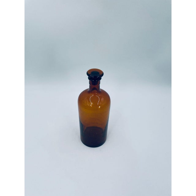 Vintage-style apothecary bottle, made of high-quality glass. The bottle is stained brown to protect the contents from UV...