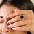 This elegant engagement ring features a stunning 5-carat oval-cut deep blue sapphire as the centerpiece, securely held by...