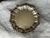 This classic decorative silverplate tray has an ornate scalloped edge rim and tripod feet elevating the platter 1 3/4"...