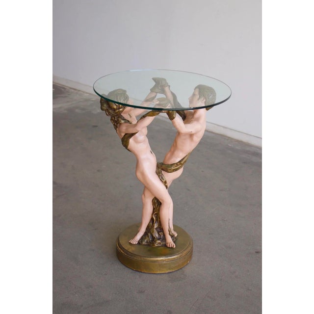 W24 D24 H33.5 Vintage French figural table featuring a painted neoclassical sculpture base and removable glass top. The...