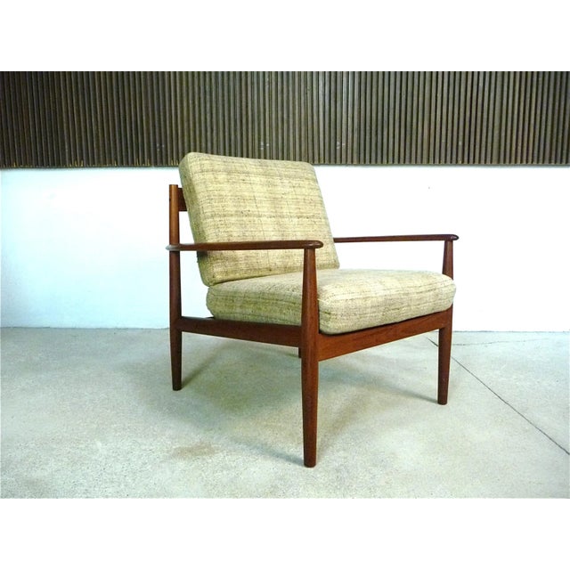 This Danish teak easy chair was designed by Grete Jalk in the early 1960s for France & Son, later Cado. The chair features...
