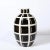 This bold and striking Mid-Century Modern ceramic vase was realized in the United States circa 1970. It features an...