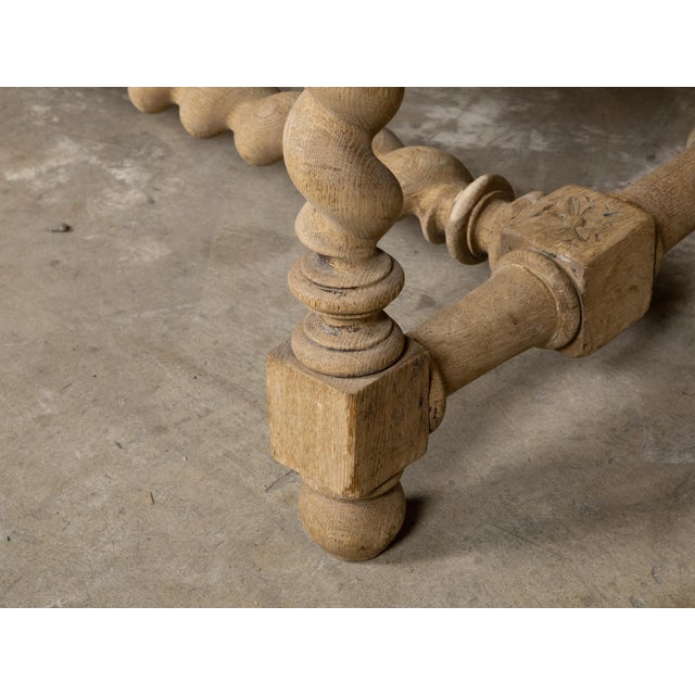An English bleached wood bench from circa 1900 with barley twist base and custom linen upholstery. This exquisite English...
