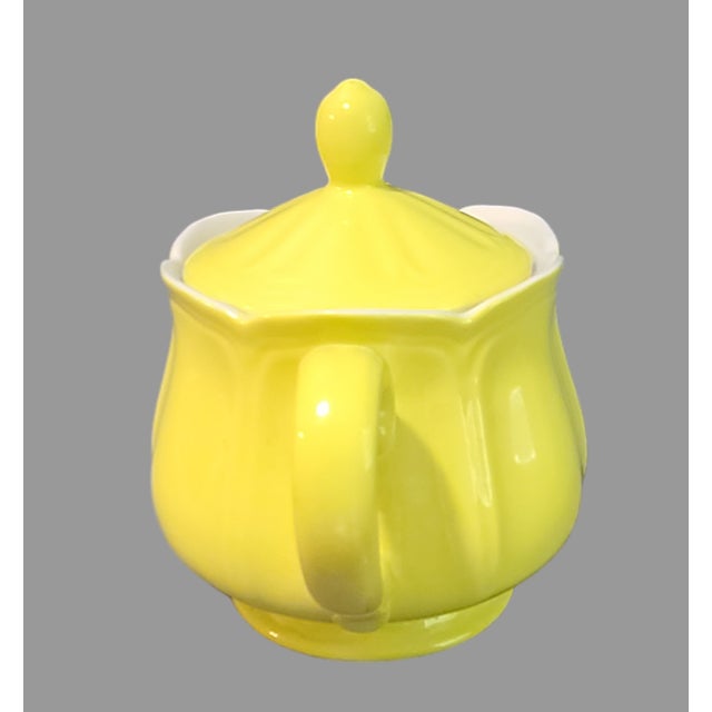 This vintage sugar bowl is a beautiful addition to any kitchen or collectibles collection. The yellow ironstone material...
