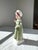 The Royal Doulton Figurine "Ruth" HN 2799 is a late-20th-century bone china figure depicting a young woman in a flowing...