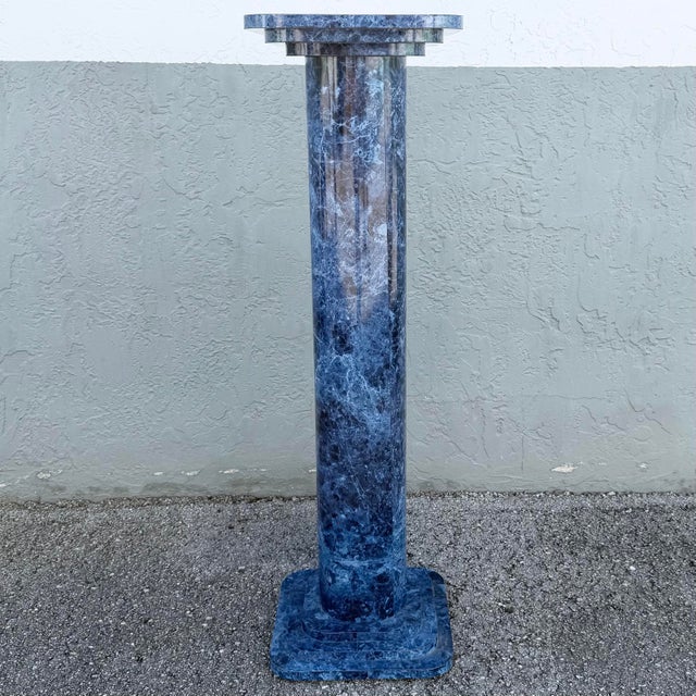 Striking vintage Postmodern pedestal featuring a dramatic faux blue marble finish with rich navy, black, gray, and white...