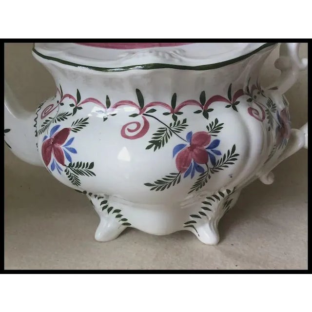 An Antique (circa 1830-1850) English, Staffordshire Teapot. The teapot is made from soft paste porcelain and is entirely...