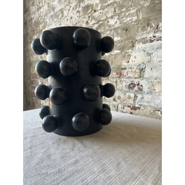 Striking and sculptural, this matte black ceramic vase brings serious edge to your shelf or table. Featuring a cylindrical...