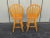 These are vintage bar or counter chairs from the 1970s or 1980s, constructed from solid oak wood. They feature a classic...