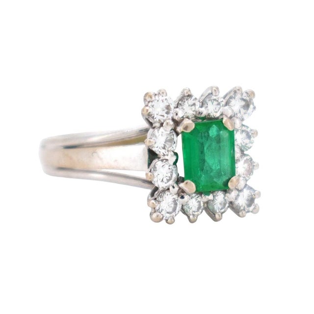 A beautifully balanced vintage cluster ring (circa 1970), masterfully crafted in 14k white gold. At the heart of this...