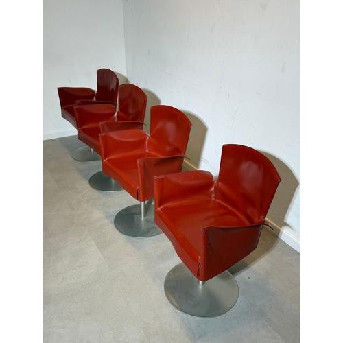 Elegant swivel armchair manufactured by Frag Italia, upholstered in high-quality red leather. A refined Italian design...