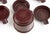 The set includes multiple individual ashtrays that nest or stack inside a central holder or caddy. This design was popular...