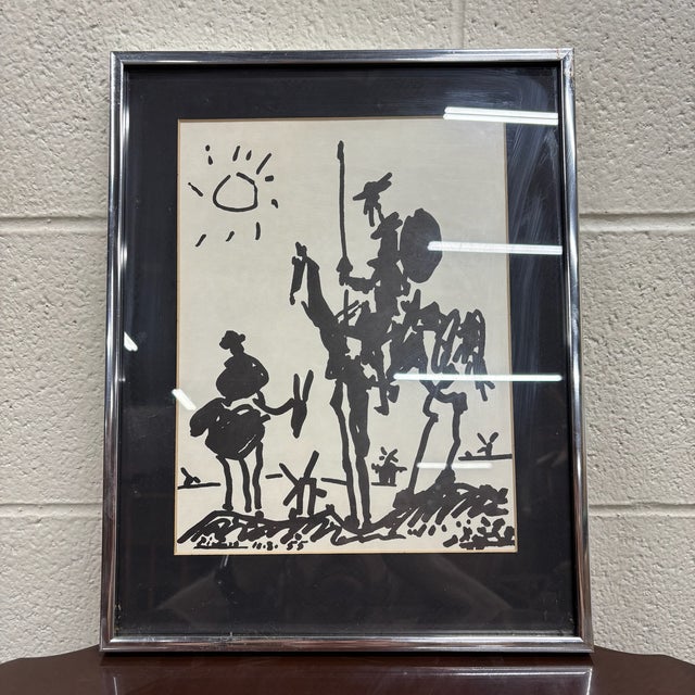 This is a vintage framed print of the iconic 1955 Don Quixote illustration by Pablo Picasso, created to commemorate the...