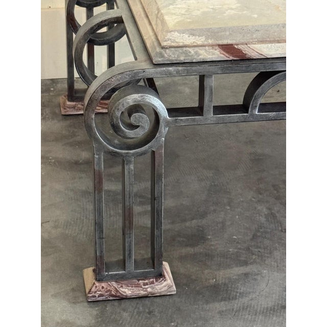 Thick marble top with tones of pink, rose white, beige and brown. Base is solid wrought iron with matching marble feet....