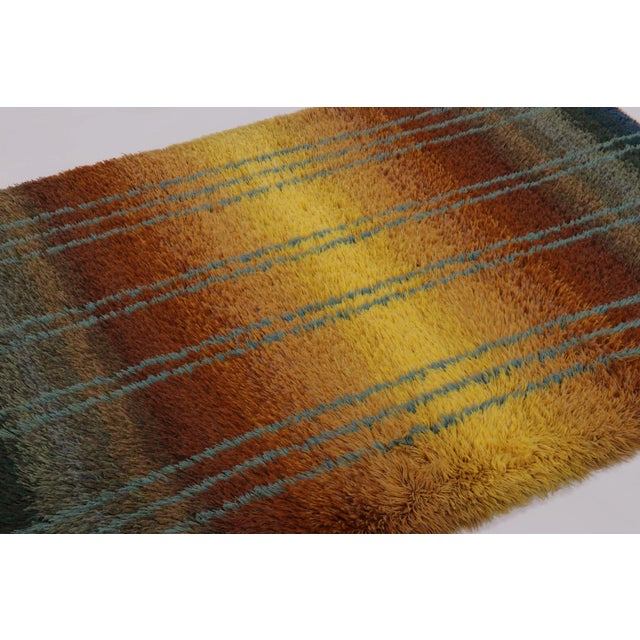 Hand-knotted in lush, high-pile wool in Sweden circa 1960-1970, this 4x6 vintage Swedish Rya rug is a bold new addition to...