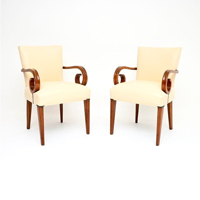 A beautiful and stylish pair of Art Deco walnut and leather armchairs. They were made in England, they date from the...
