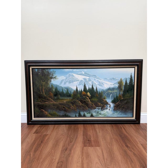 Large-scale vintage 1970s landscape oil painting depicting a snowcapped mountain range with evergreen woods, river rapids,...