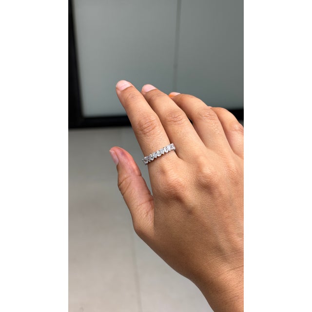 This modern full eternity band ring features 2.3 carats of pear-cut diamonds, set in 18K white gold. Each pear cut diamond...
