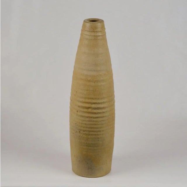 Hand turned studio pottery floor vase in elongated form has a natural finish. The vase is part of our large collection of...